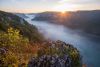Die Donau hat am Südrand der Schwäbischen Alb einen Canyon in die Berge gegraben. Während der Fluss im Tal noch unter dem Morgennebel liegt, geht auf den Bergen der Alb die Sonne auf.